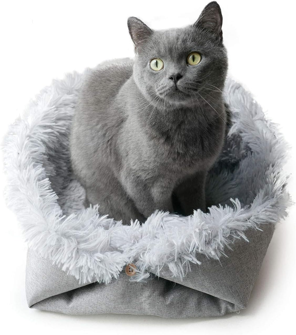 grey furry pet bed used flat as a mat
