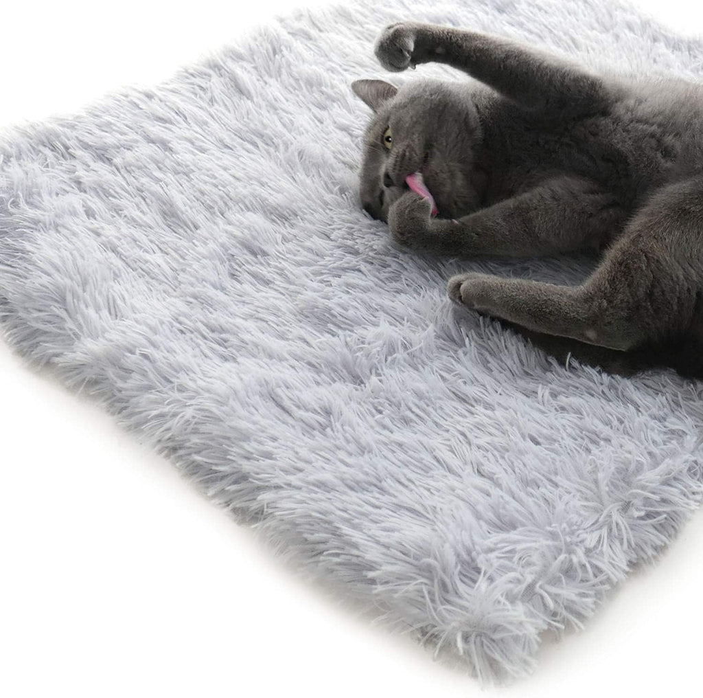 grey furry pet bed used flat as a mat