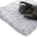 grey furry pet bed used flat as a mat