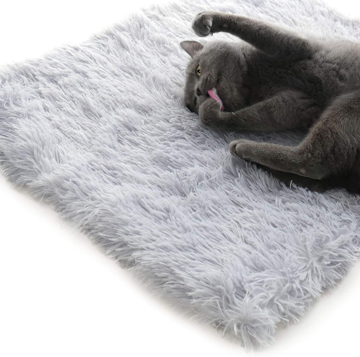 grey furry pet bed used flat as a mat